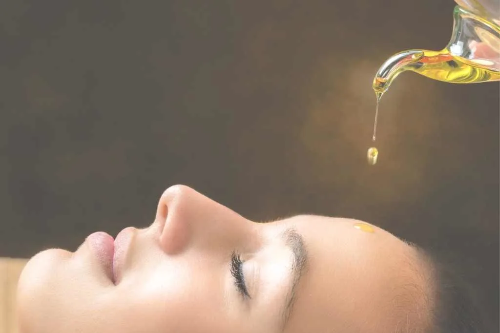 ayurveda treatment-aromatic-oil-dripping-on-female-face
